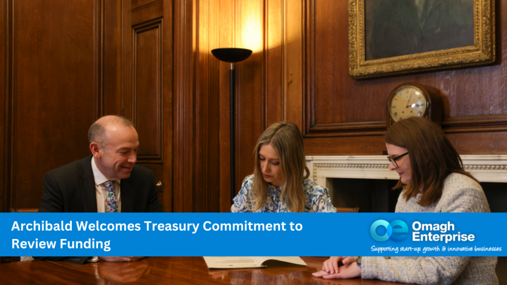 Secretary of State Rt Hon Chris Heaton-Harris MP, Finance Minister Dr Caoimhe Archibald MLA and Chief Secretary to the Treasury, Rt Hon Laura Trott MBE MP, signing following Executive approval on the Interim Fiscal Framework took place in London. Blue banner along the bottom. White text "Archibald Welcomes Treasury Commitment to Review Funding" Omagh Enterprise logo within the banner