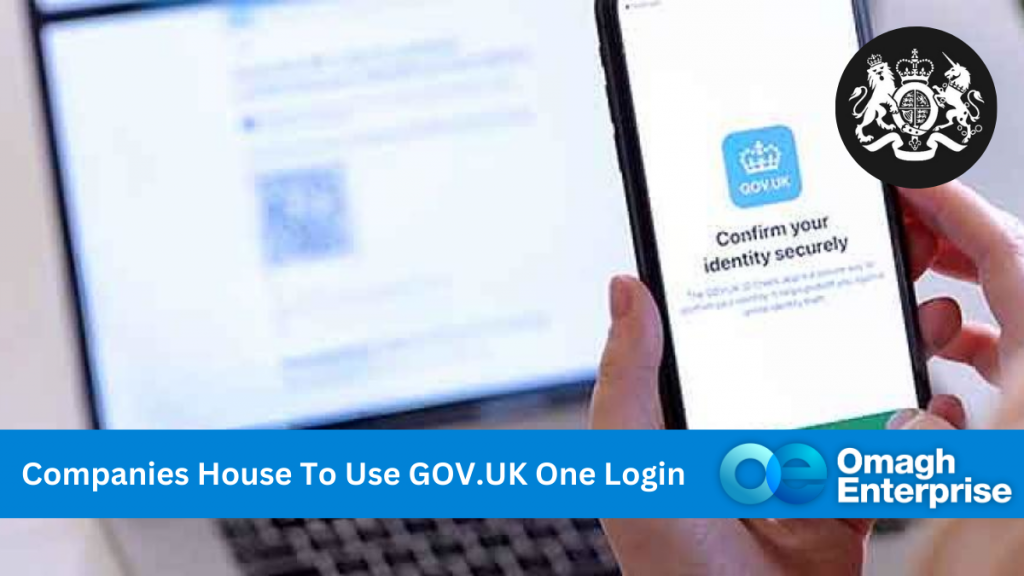 A laptop and mobile phone opened at the Companies House website. Blue banner along the bottom, with white text. "Companies House To Use GOV.UK One Login" Omagh Enterprise logo within banner.