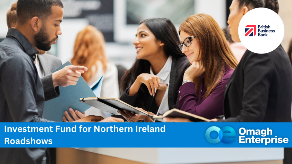 Two women working at a desk in a business roadshow, answering a man's queries. Blue banner along the bottom,with white text. "Investment Fund for Northern Ireland Roadshows" Omagh Enterprise logo within the blue banner.