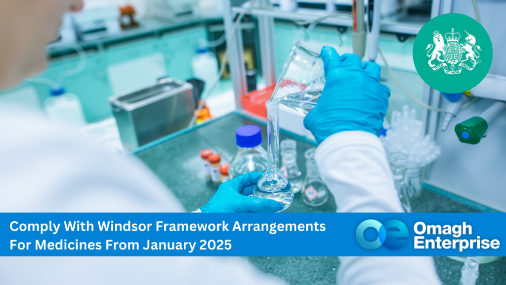 A lab technician wearing blue gloves pouring liquid into a flask in a laboratory. Text overlay: Comply With Windsor Framework Arrangements For Medicines From January 2025. Omagh Enterprise logo on the bottom right.