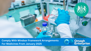 A lab technician wearing blue gloves pouring liquid into a flask in a laboratory. Text overlay: Comply With Windsor Framework Arrangements For Medicines From January 2025. Omagh Enterprise logo on the bottom right.