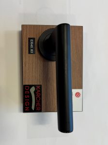 Black door handle with a rectangular wooden base. The base has labels with "ERA 583" and "Karcher Design" along with a small red logo.