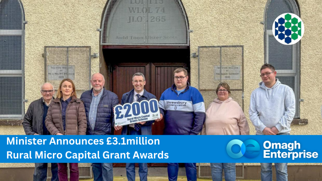 Pictured with Minister Muir are members of the Auld Toon Scots society in Kells along with Briege Conway manager of the Northern Area Community Network. Pictured left to right, William Thompson, Briege Conway, Mervyn McDonald, Minister Andrew Muir, Karl Barr, Karen Strain, and Andrew Barr. Text: "Minister Announces £3.1million Rural Micro Capital Grant Awards" with DAERA and Omagh Enterprise logos.