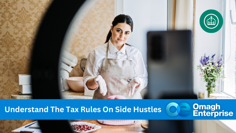 A woman in an apron stands in a kitchen, holding a ball of dough. Shes framed by a ring light, looking towards a smartphone on a stand. A banner reads Understand The Tax Rules On Side Hustles with the Omagh Enterprise logo.