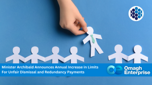 A hand picks up a paper figure from a row on a blue background. Text below mentions Minister Archibald and changes in limits for unfair dismissal and redundancy payments. Omagh Enterprise logo included.