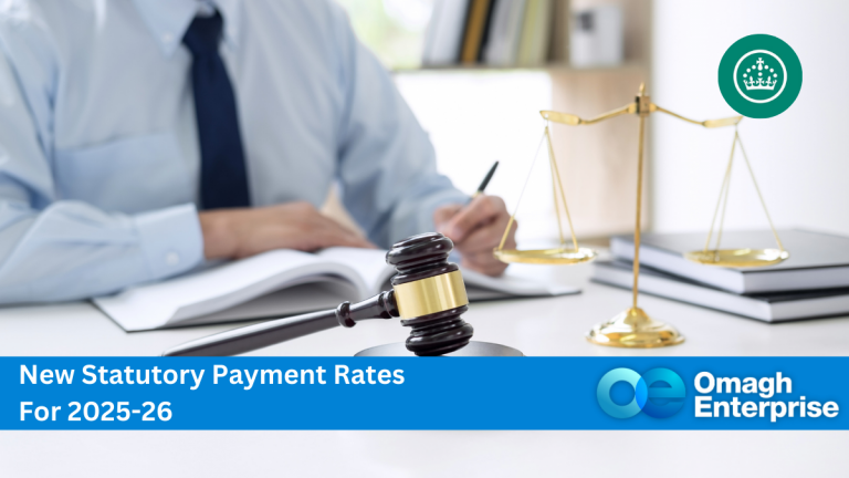 Person writing at a desk with a gavel and scales of justice. Text reads: "New Statutory Payment Rates For 2025-26, Omagh Enterprise.