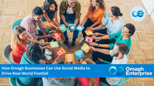 A group of people sitting in a circle holding paper cutouts of social media and technology icons, with a banner about using social media to drive business footfall.