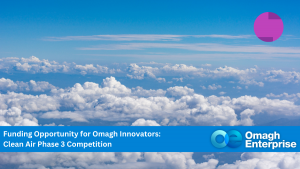 A blue sky with white clouds, overlaid with text promoting a Clean Air Phase 3 funding competition by Omagh Enterprise.