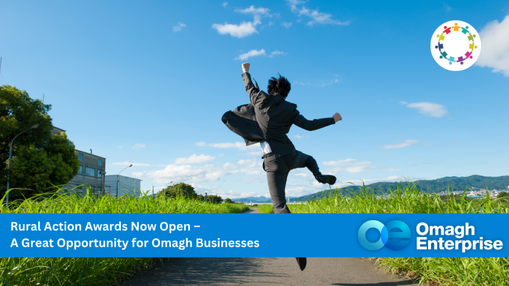 A person in a suit jumps joyfully on a rural path with green grass, blue sky, and buildings in the background. Text promotes the Rural Action Awards for Omagh businesses.