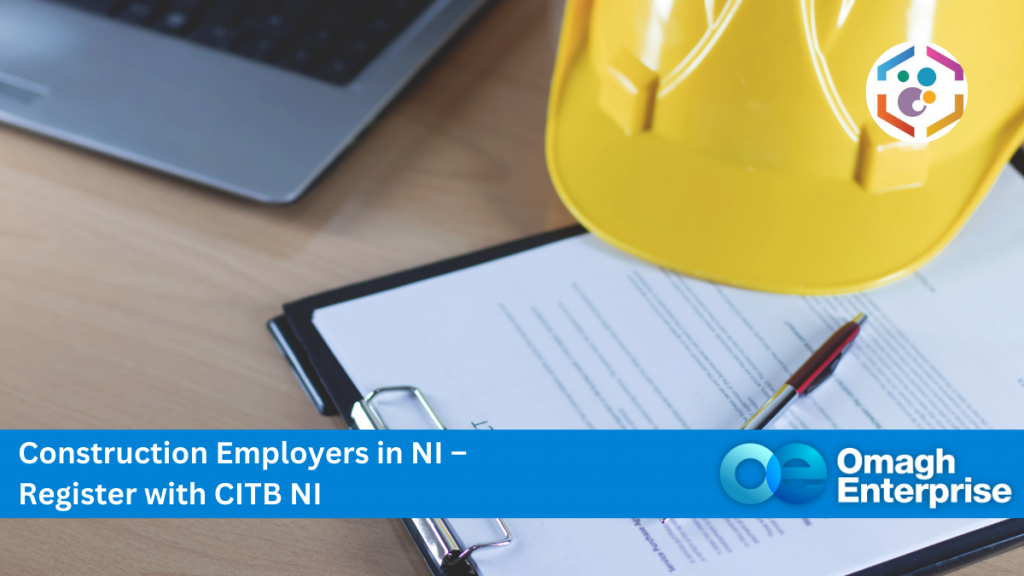 A clipboard with documents, a pen, a yellow hard hat, and part of a laptop on a desk; overlay text promotes CITB NI registration for construction employers.