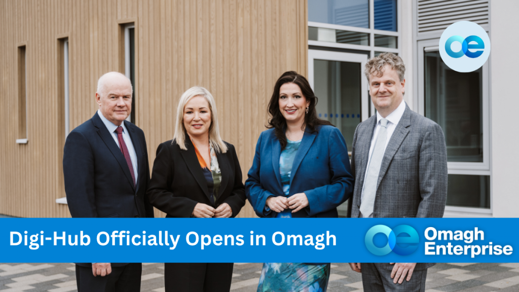Dr Nick O'Sheil, First Minister Michelle O'Neill, deputy First Minister Emma Little-Pengelly and Marcus Isherwood in business attire stand outside the opening of Omagh Enterprise Digi-Hub; text reads "Digi-Hub Officially Opens in Omagh, Omagh Enterprise.