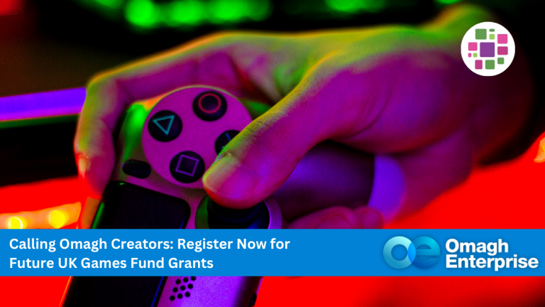 Close-up of a hand holding a video game controller with a bright, colorful background; text overlay invites Omagh creators to register for UK Games Fund Grants. Omagh Enterprise logo present.