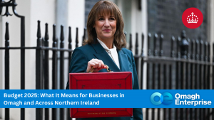 Rachel Reeves in a suit holds a red briefcase outside, with text about Budget 2025 and its impact on businesses in Omagh and Northern Ireland at the bottom of the image.