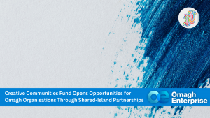 Banner with a blue paint streak, Omagh Enterprise logo, and text about Creative Communities Fund opening opportunities for Omagh organizations through shared-island partnerships.