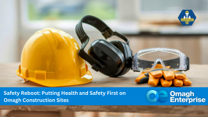 A yellow hard hat, black ear protection, safety goggles, and gloves rest on a wooden surface with a blurred background.
