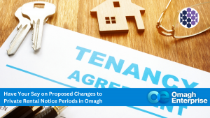 Set of house keys, a wooden house model, glasses, and a tenancy agreement document on a desk, with an Omagh Enterprise banner about private rental notice period changes.