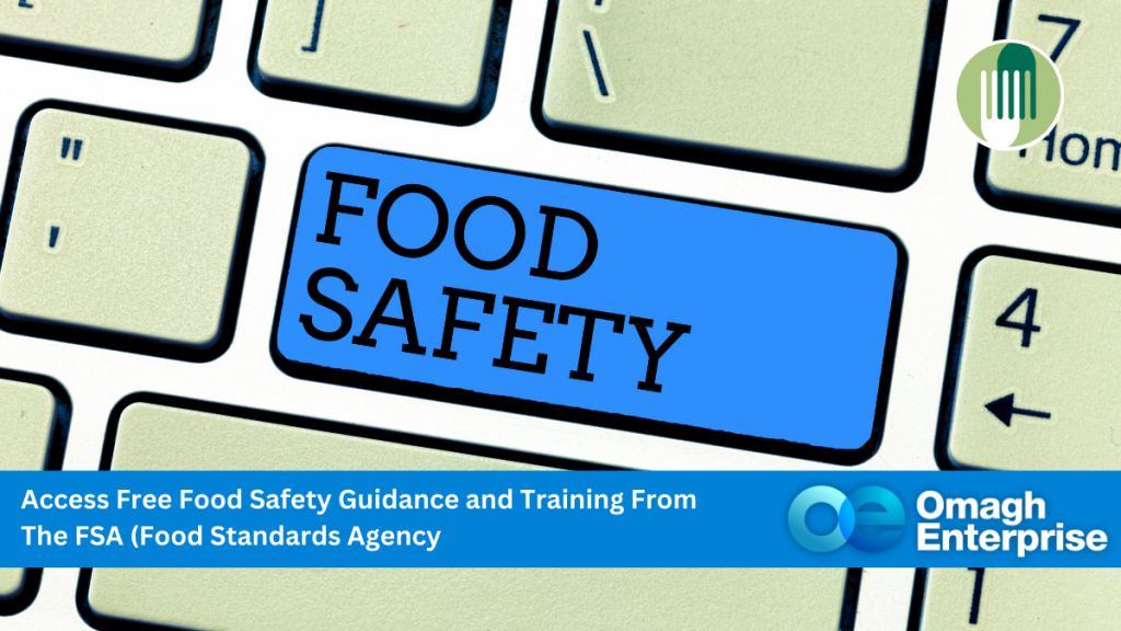 A keyboard with a blue key labeled "FOOD SAFETY," promoting free food safety guidance and training from the Food Standards Agency, by Omagh Enterprise.