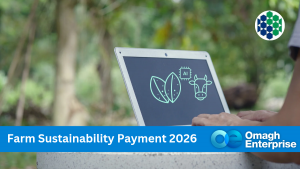 A person uses a laptop displaying leaf and cow icons outdoors, with Farm Sustainability Payment 2026 and Omagh Enterprise logo in a blue banner at the bottom.
