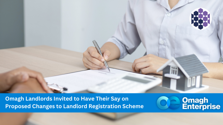 Two people sit at a desk with documents, a pen, a calculator, and a small model house, discussing landlord registration changes. A text banner and Omagh Enterprise logo are visible.