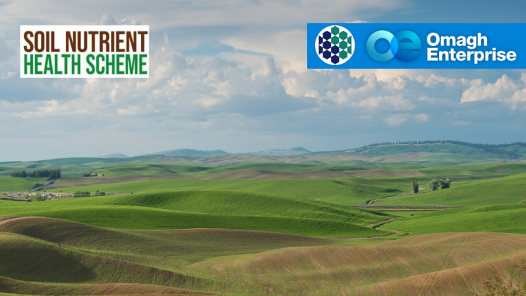Green rolling hills under a cloudy sky with "Soil Nutrient Health Scheme" and "Omagh Enterprise" logos in the top corners.