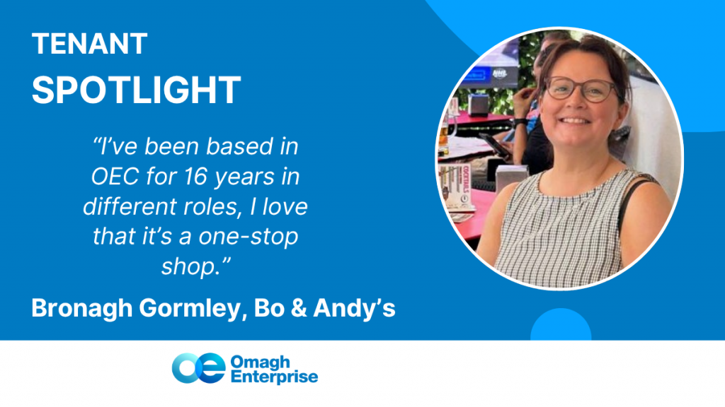 A smiling Bronagh wearing glasses and a checkered top is featured in a blue graphic. Text highlights her as a tenant at Omagh Enterprise for 16 years and includes a quote about enjoying the one-stop shop environment.