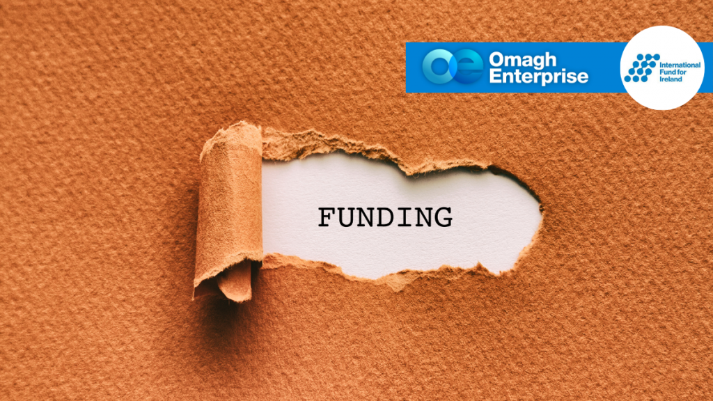 A torn piece of brown paper revealing the word "FUNDING," with Omagh Enterprise and International Fund for Ireland logos in the top right corner.