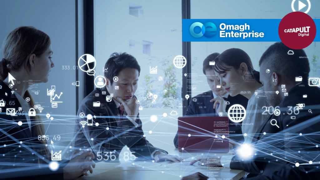 Five people sit at a table with laptops, overlaid with digital network icons. Logos for Omagh Enterprise and Catapult Digital are visible in the top right corner.