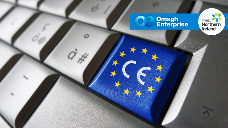 A keyboard features a blue key with the CE mark surrounded by yellow EU stars. Omagh Enterprise and Invest Northern Ireland logos appear in the top right corner.
