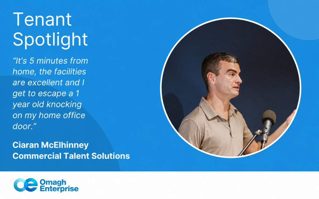 Ciaran speaking at a microphone next to text about tenant spotlight, featuring a quote on remote work and facilities at Omagh Enterprise.