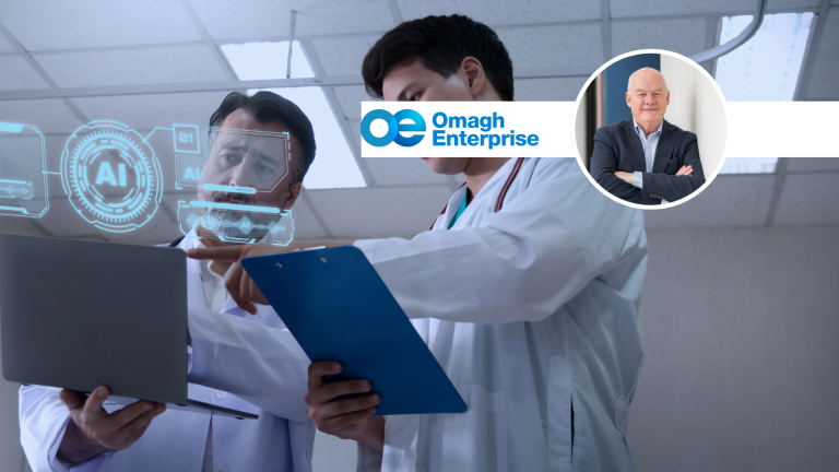 Two doctors in lab coats look at a laptop displaying a glowing digital AI interface, with the Omagh Enterprise logo and a circular inset photo of Nick in a suit.