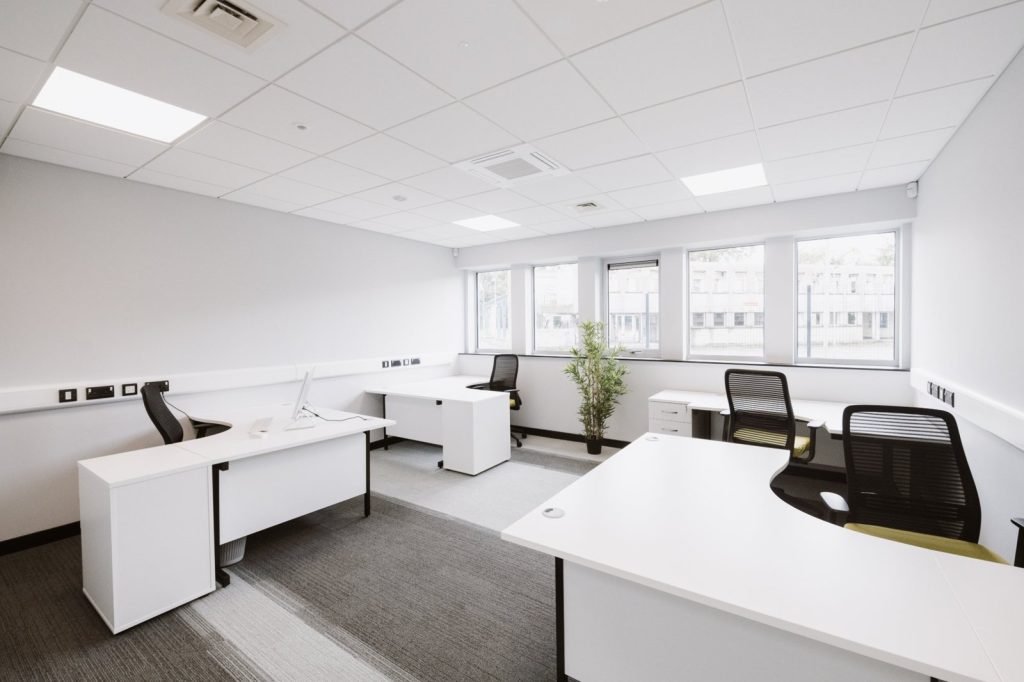 Coworking space with white dedicated desks and office chairs at Omagh Enterprise Digi-Hub, Old Mountfield Road, Omagh, County Tyrone