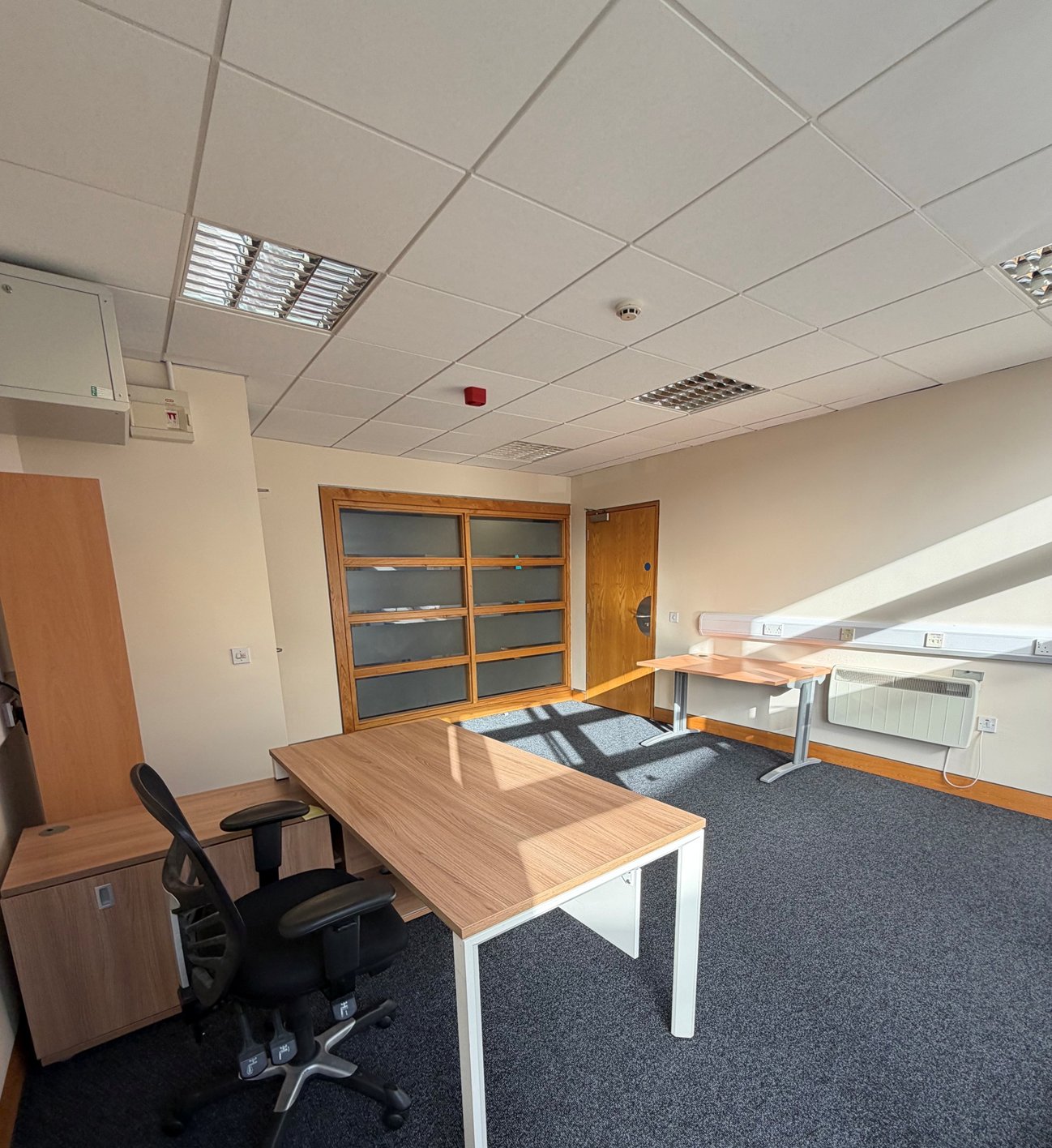 Private office with desks, storage cabinet and wall heater at Omagh Enterprise, Great Northern Road, Omagh