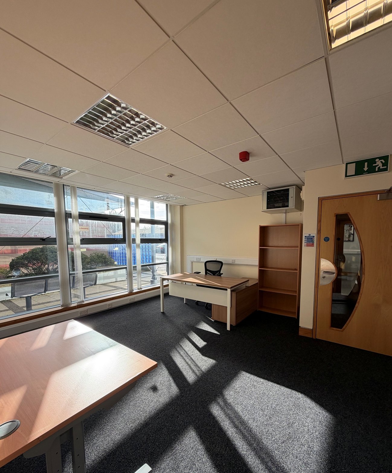 Sunny private office with floor-to-ceiling windows and desks at Omagh Enterprise, Great Northern Road, Omagh